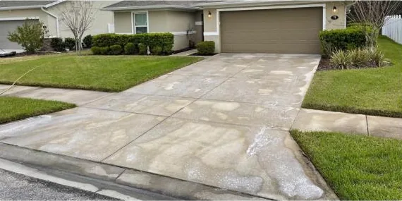 Before: concrete driveway at a one-story home