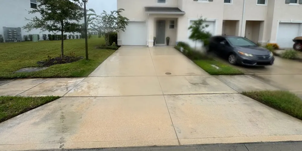 After: townhome driveway with dark staining, cleaned