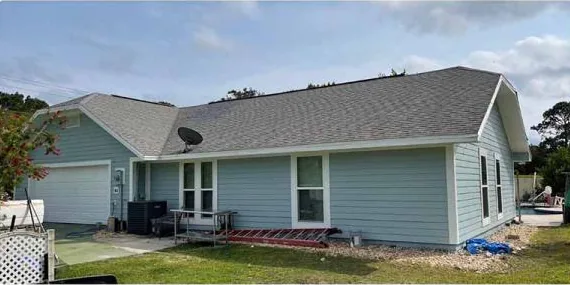 After: light blue siding on a one-story home, cleaned