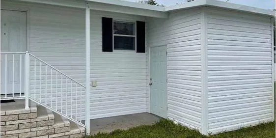 After: white siding and entry steps, cleaned
