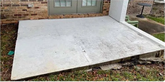 After: concrete patio covered in black mildew, cleaned