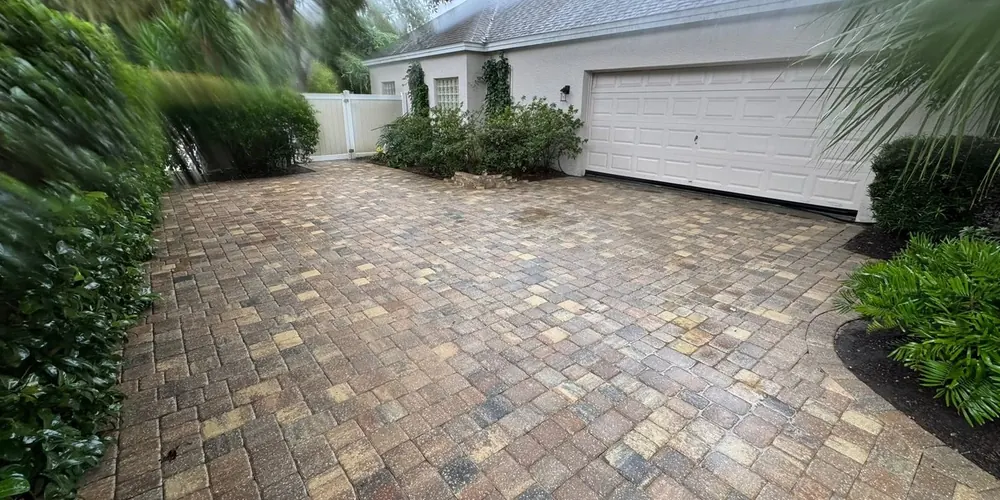 After: paver driveway beside a garage, cleaned