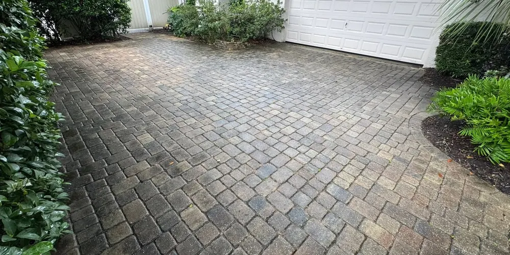 Before: paver driveway beside a garage