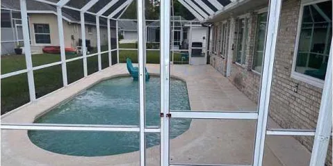 After: pool deck inside a screen enclosure, cleaned