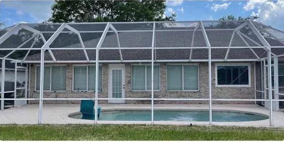 After: pool screen enclosure from the yard, cleaned