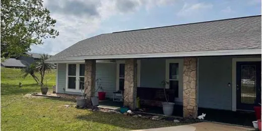 After: front of a home with a shingle roof, cleaned