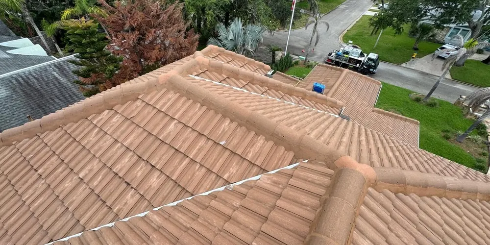 After: terracotta tile roof darkened by algae, cleaned