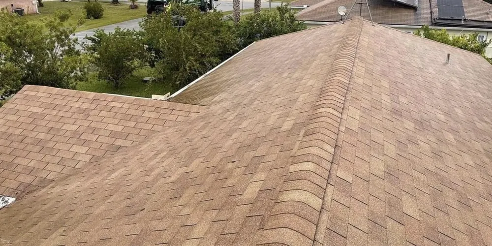 After: shingle roof with dark algae streaks, cleaned