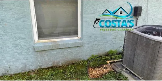 After: rust stains under a window on a stucco wall, cleaned