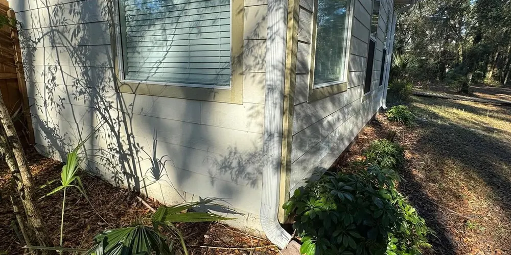 After: corner of a home stained orange by sprinkler water, cleaned