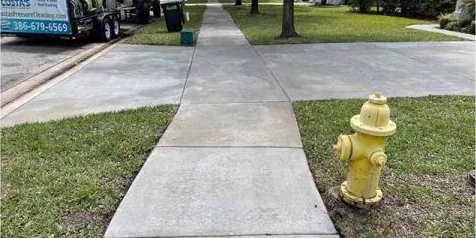 After: stained sidewalk next to a fire hydrant, cleaned