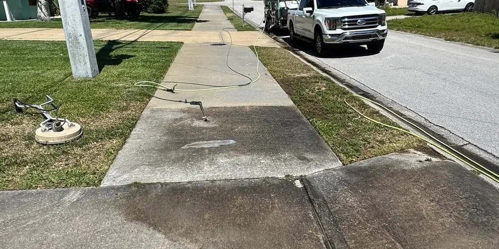 Before: dark, mildewed sidewalk along a street