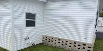 After: white vinyl siding with green mildew, cleaned