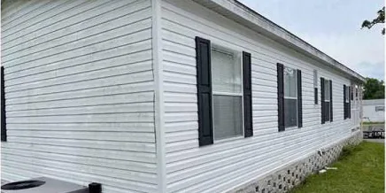 Before: long wall of vinyl siding
