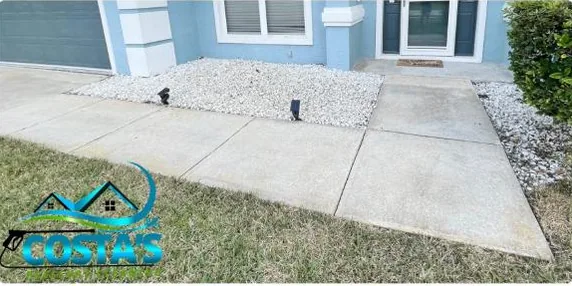 After: front walkway beside a rock bed, cleaned