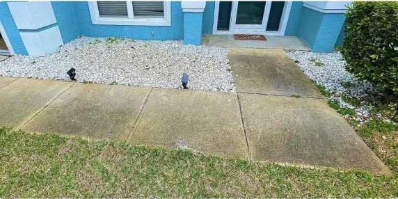 Before: front walkway beside a rock bed